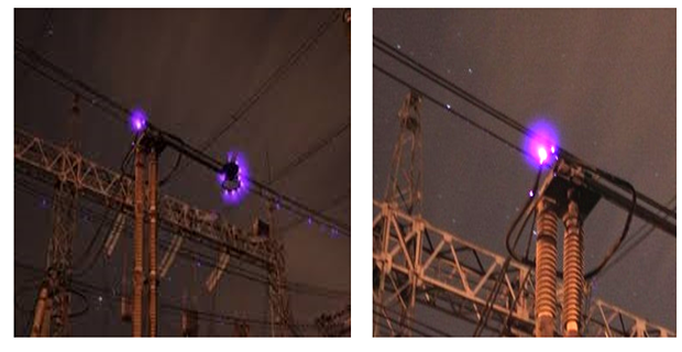 Pemandangan lebar saluran udara dengan cahaya biru-ungu corona discharge di sepanjang kabel